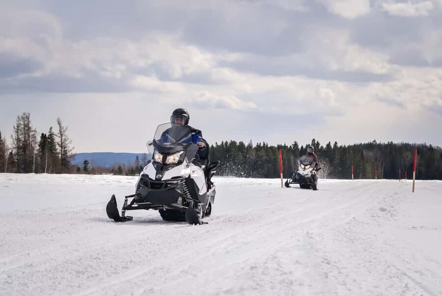 15 min. Tadoussac: Snowmobile Expedition in Saguenay Fjord - Starting from Sacré-Coeur in the winter dark