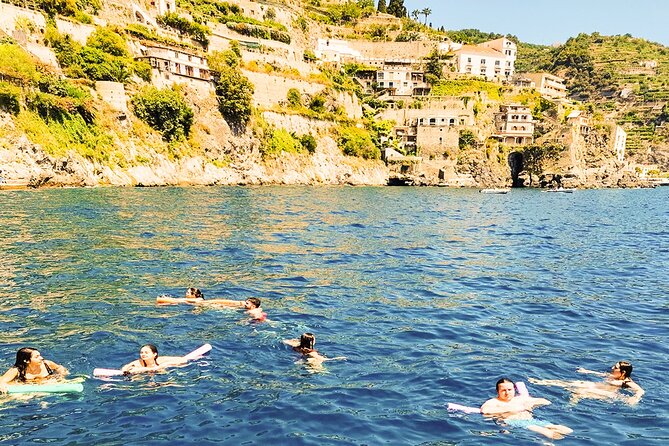 From Amalfi: Coast & Furore Fjord Boat Tour with Swim Break - Praiano, Isola dei Galli, and distant Capri views