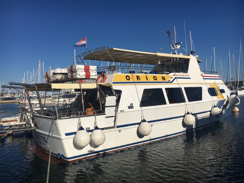 From Pula: Day Cruise to Rovinj, Lim Fjord, and Red Island - Leaving Pula with the amphitheater and Brijuni in view
